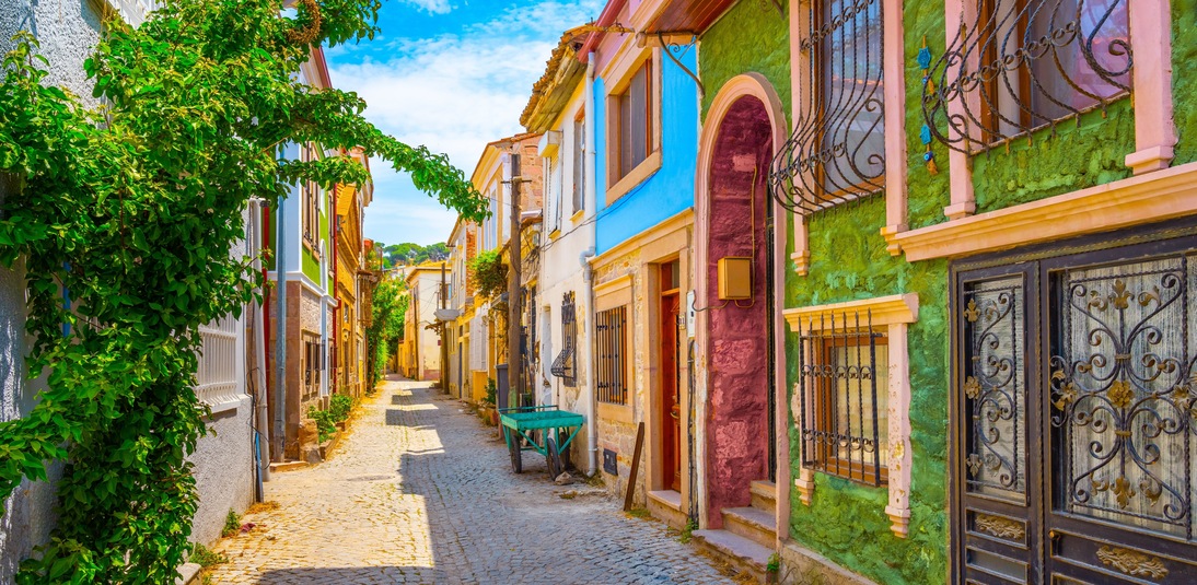 street view with colorful houses in summer. Historical Greek houses in europe. Travel routes for turkey journey. Village landscape on a hot summer day. Ayvalik city, Turkey.