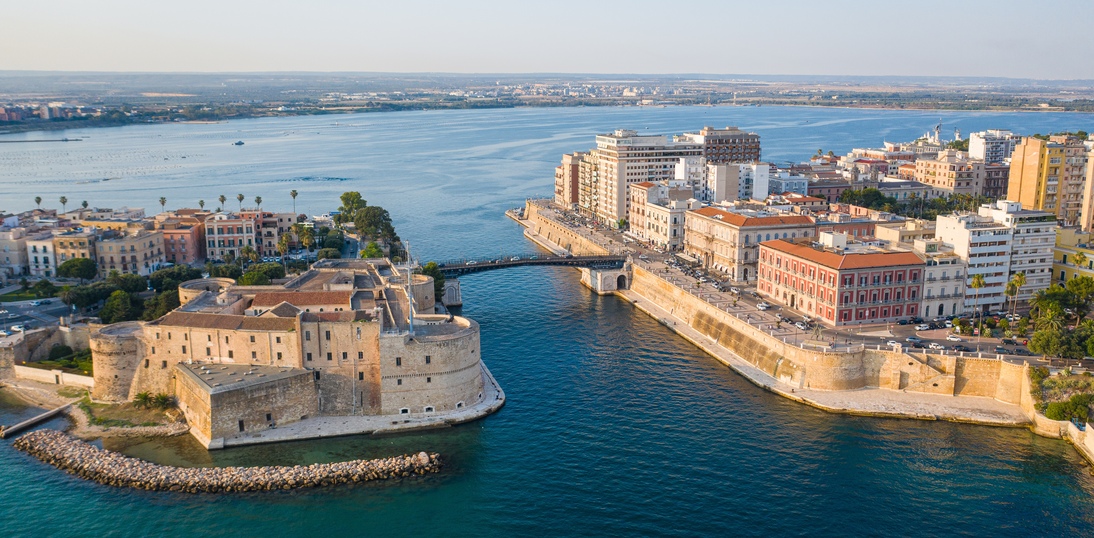 Beautiful panoramic aerial view photo from flying drone on Old medieval Aragonese Castle on sea channel, old town of Taranto city, Puglia (Apulia), Italy (Series)
